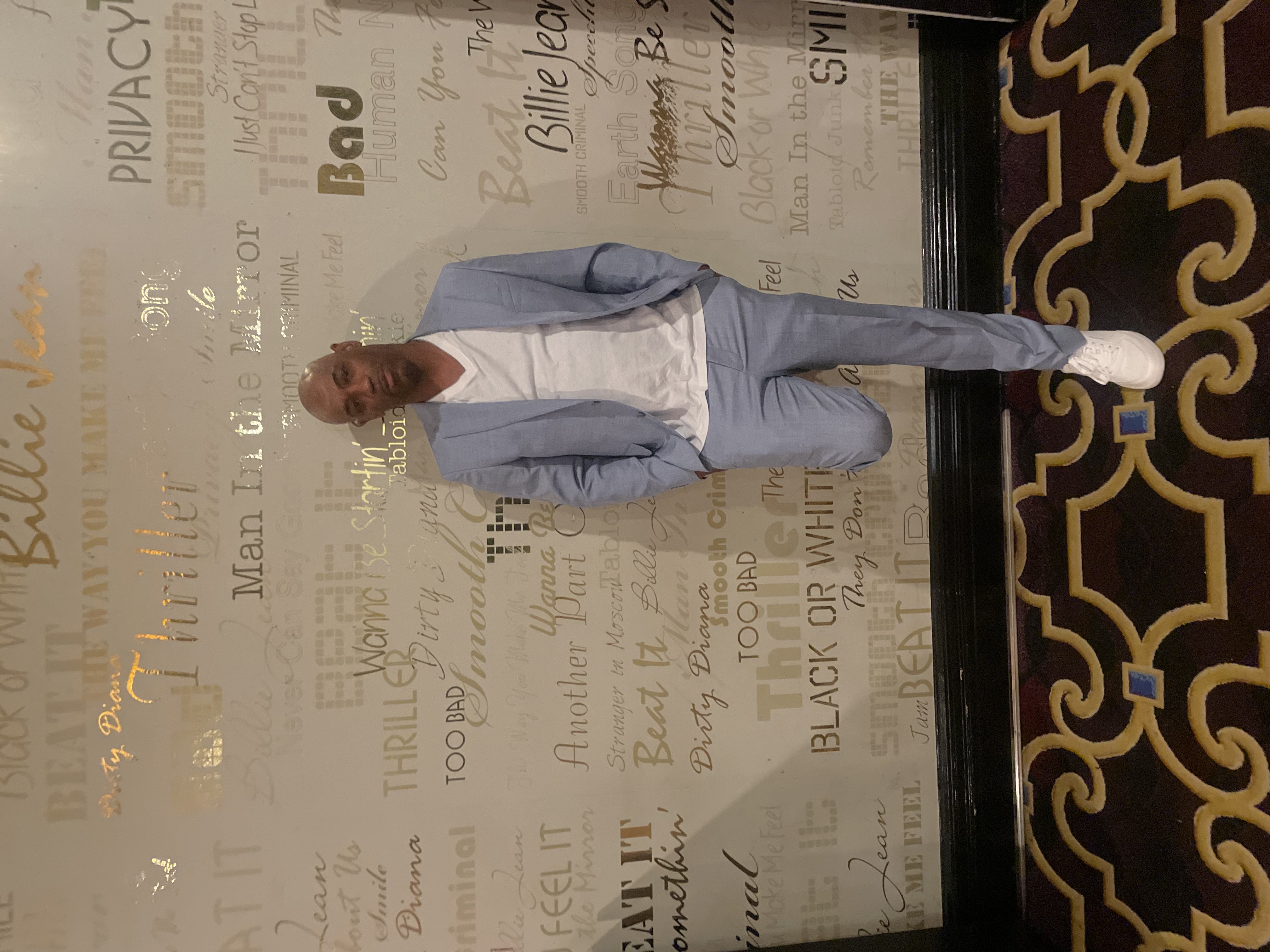 Family member in a blue suit at a Michael Jackson-themed venue